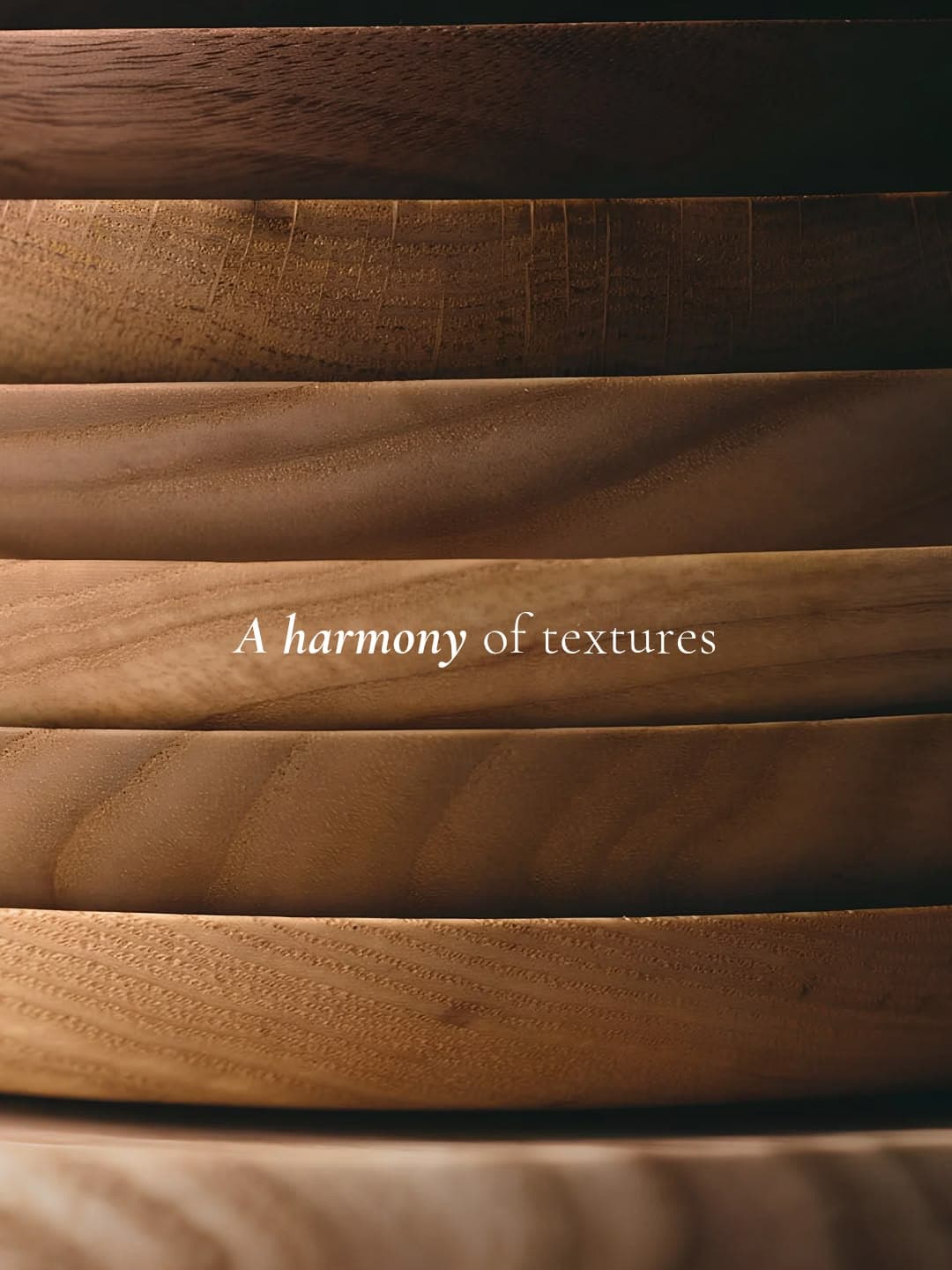 Stacked handcrafted wooden plates showing natural grain and texture